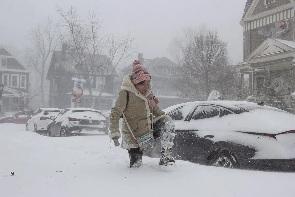 A resident navigating deep snow amid a large winter storm, in Buffalo, New York, on Dec 24, 2022.