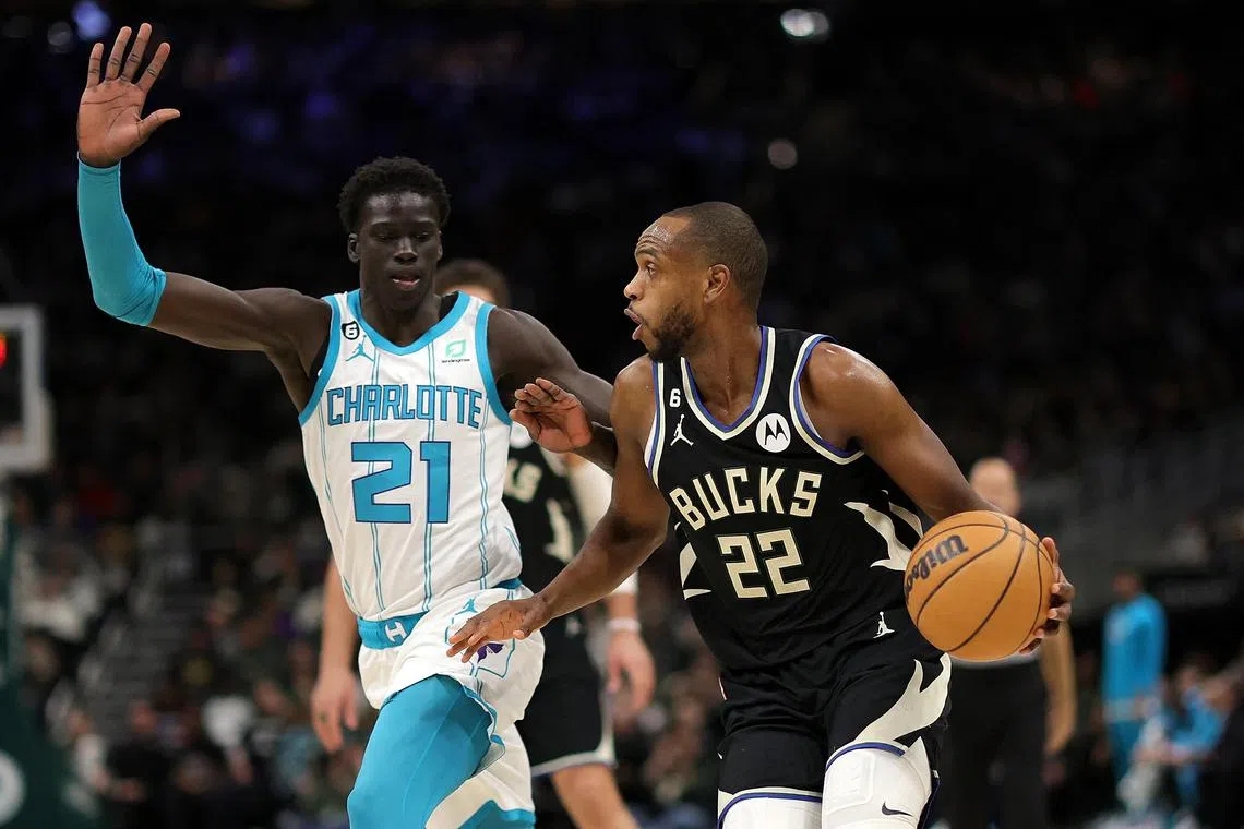 Khris Middleton of the Milwaukee Bucks is defended by JT Thor of the Charlotte Hornets during the first half at Fiserv Forum on Jan 31, 2023.