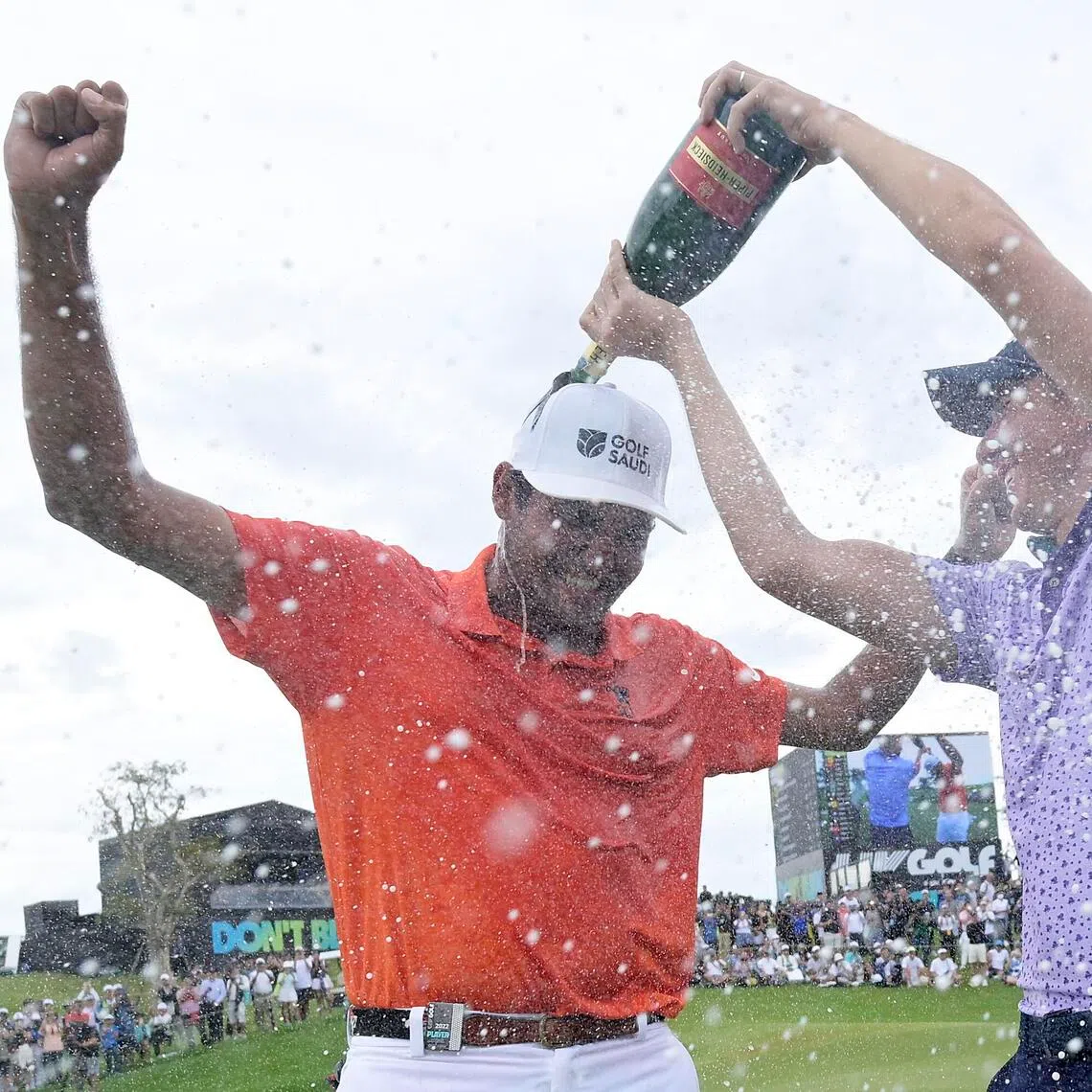 Eugenio Lopez-Chacarra of Fireballs GC celebrates his win on the 18th green as teammates Carlos Ortiz sprays him with champagne after the LIV Golf Invitational - Bangkok at Stonehill Golf Course on Oct 9, 2022 in Pathum Thani, Thailand. 