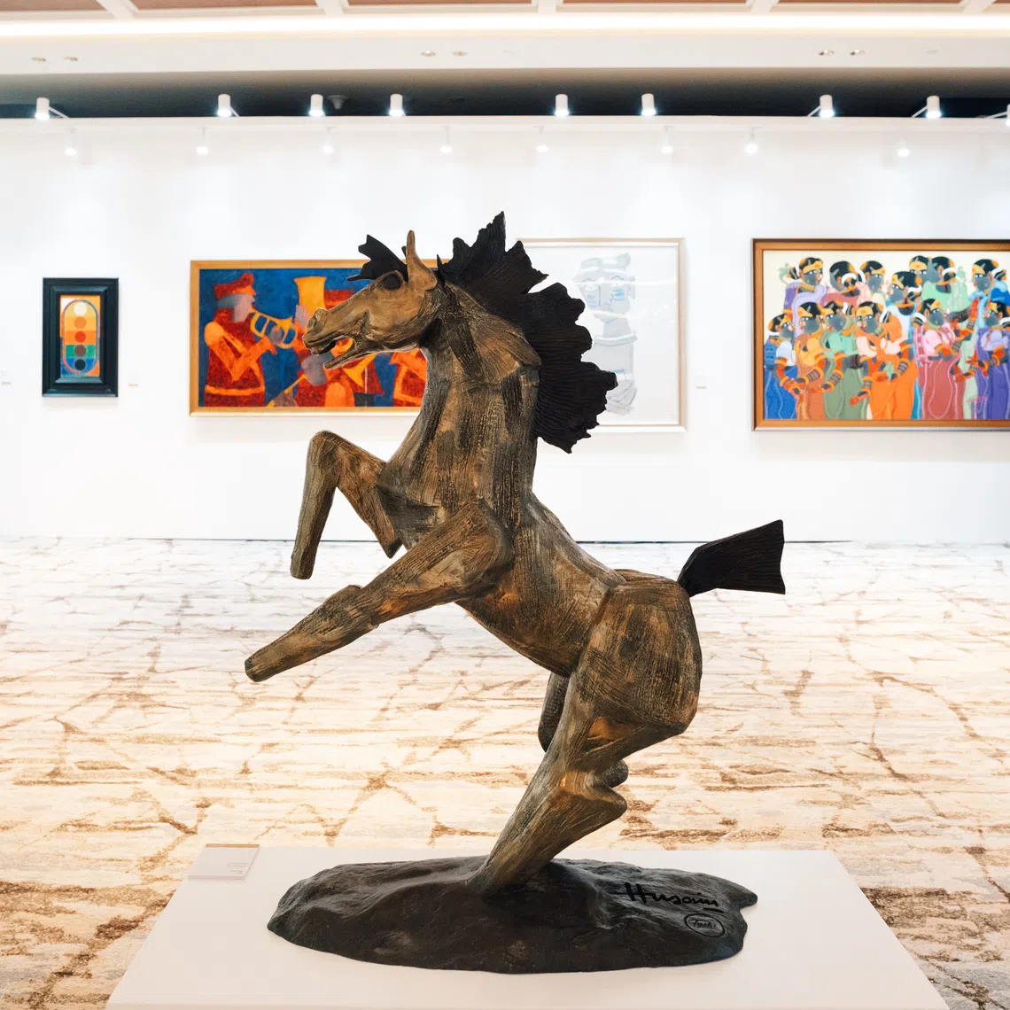 Indian online auction house AstaGuru’s inaugural Singapore exhibition. In the foreground is Smirking Horse by M. F. Husain.