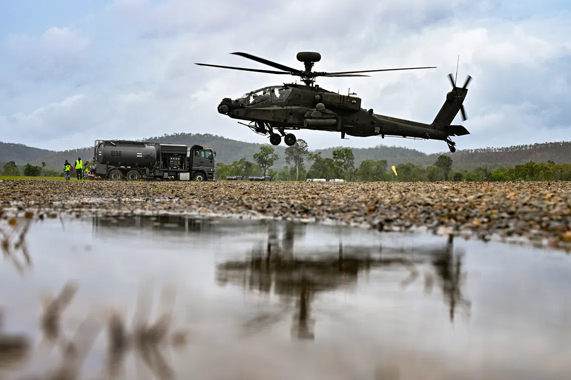 AH-64D Apache attack helicopter flying off after refueling next to the Bowser at Glen Airfield in the Shoalwater Bay Training Area in Queensland, Australia on Oct 24.