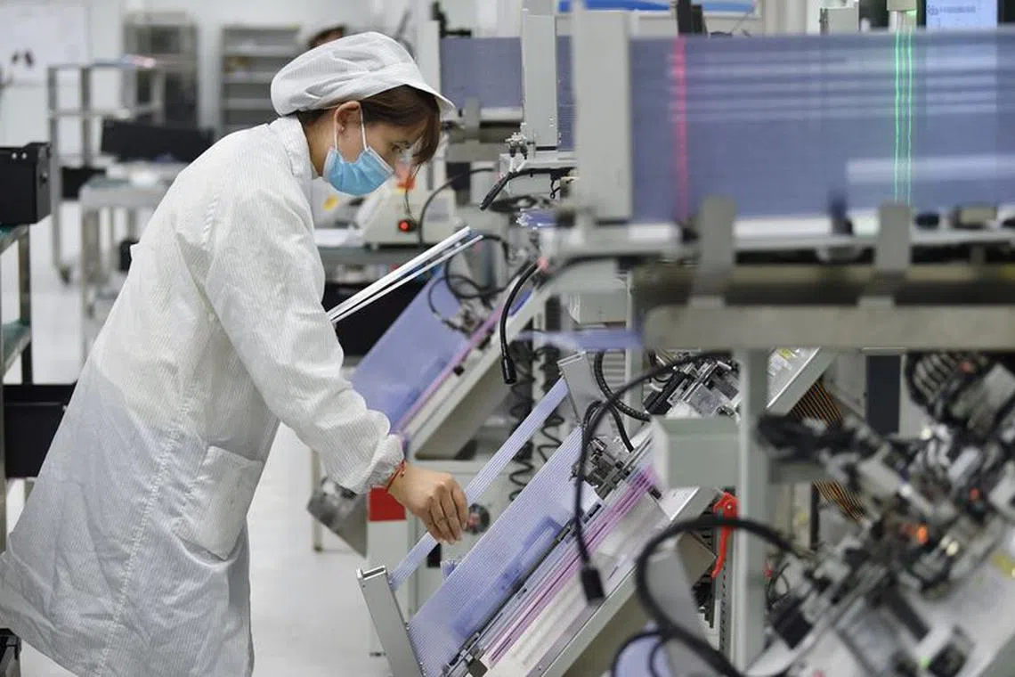 FILE PHOTO: An employee works on the production line of a semiconductor chip company in Suqian, Jiangsu province, China February 28, 2023. China Daily via REUTERS  ATTENTION EDITORS - THIS IMAGE WAS PROVIDED BY A THIRD PARTY. CHINA OUT./File Photo