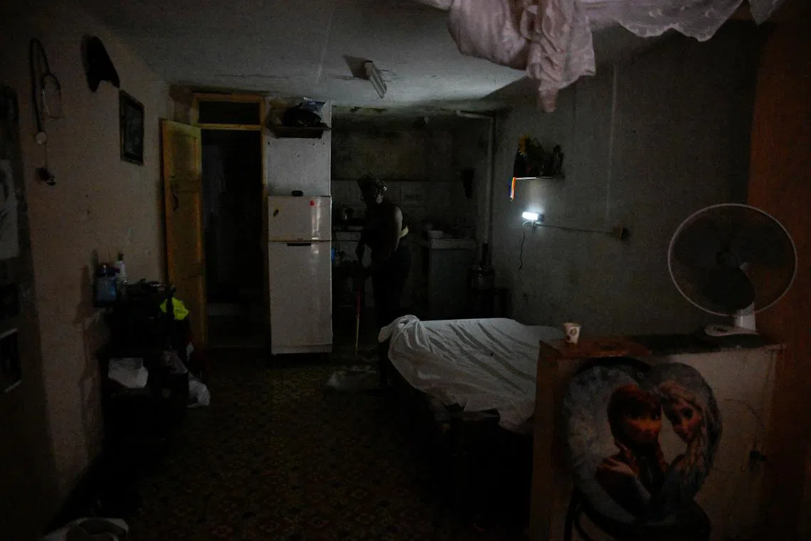 Moraima Ricardo, 62, a retired human resources professional, cleans her home during a mass blackout across most of the country, in Havana, Cuba March 4, 2026. REUTERS/Norlys Perez