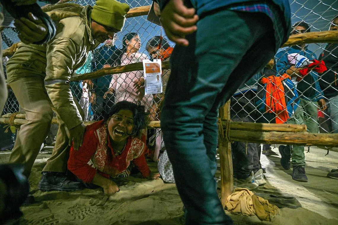 A devotee reacts at the site of a stampede amid the ongoing Maha Kumbh Mela festival in Prayagraj on January 29, 2025. (Photo by ARUN SANKAR / AFP)