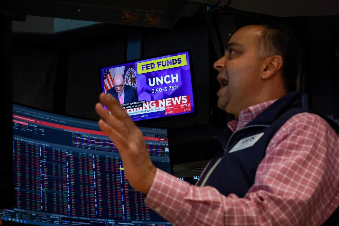 A screen displays the Fed rate announcement as a trader reacts on the floor of the New York Stock Exchange (NYSE) in New York City, U.S., March 18, 2026.  REUTERS/Brendan McDermid  