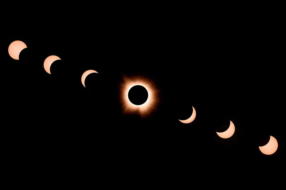 In this composite of seven photographs, the moon passes by the sun during the solar eclipse in Bloomington, Indiana, on April 8, 2024.