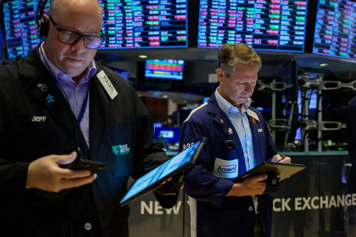 Traders work on the floor of the New York Stock Exchange.