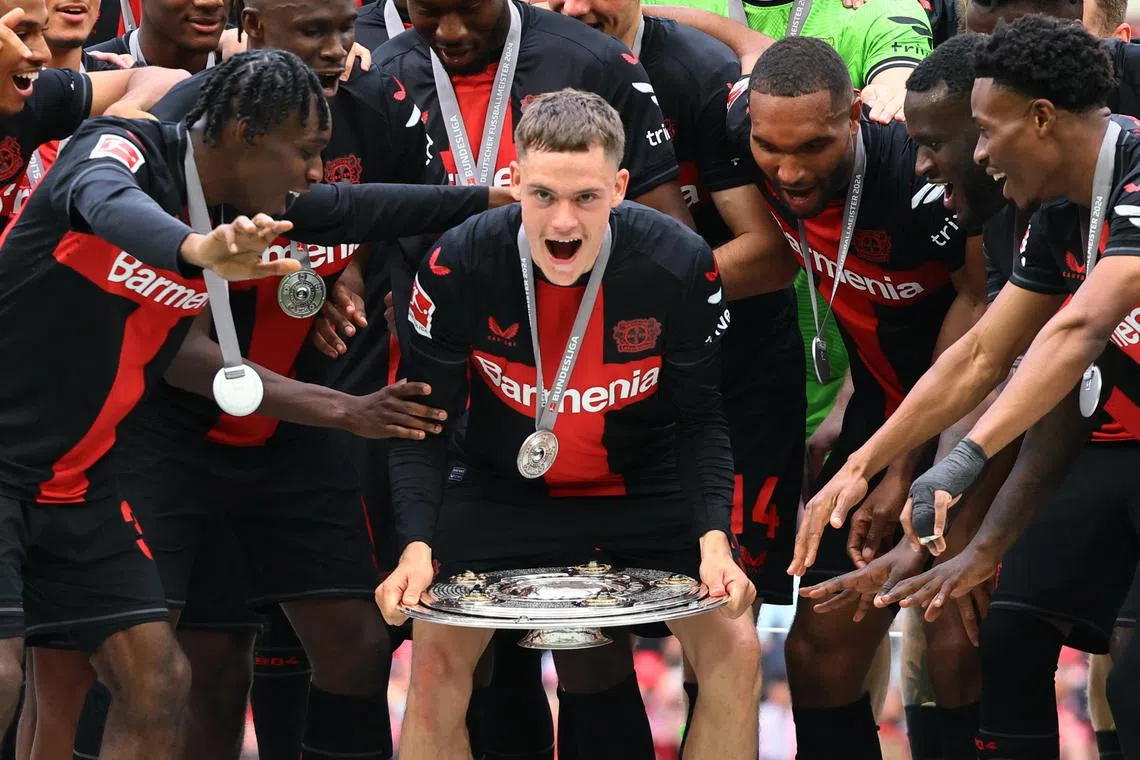 FILE PHOTO: Soccer Football - Bundesliga - Bayer Leverkusen v FC Augsburg - BayArena, Leverkusen, Germany - May 18, 2024 Bayer Leverkusen's Florian Wirtz celebrates with the trophy and teammates after winning the Bundesliga and going unbeaten REUTERS/Wolfgang Rattay