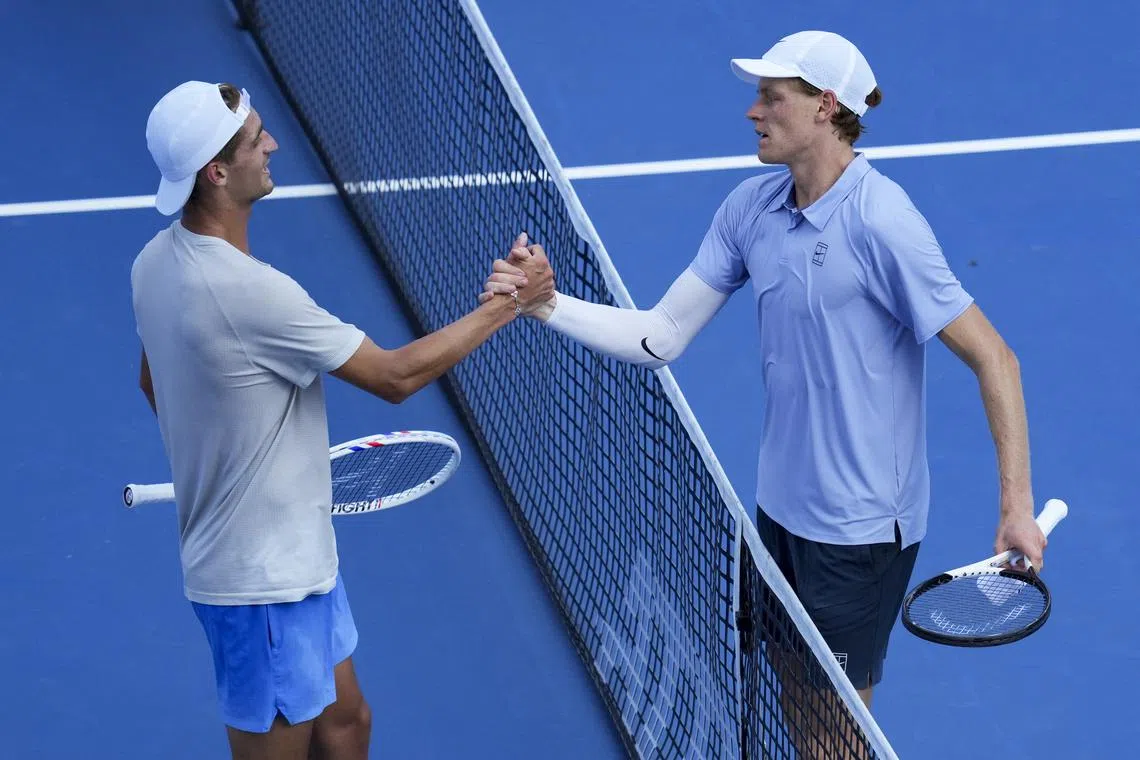 Aug 16, 2025; Cincinnati, OH, USA;  Jannik Sinner (ITA) right, meets Terence Atmane (FRA) at the net after their match during the Cincinnati Open at the Lindner Family Tennis Center. Mandatory Credit: Aaron Doster-Imagn Images