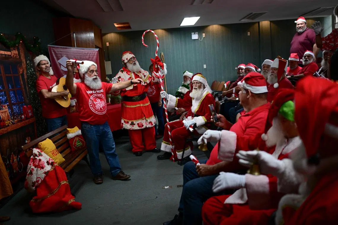 Members of the Brazil's School of Santa Claus attend their graduation ceremony at the Calouste Gulbekian Arts Center, in the city center of Rio de Janeiro, Brazil on Oct 29, 2024. This year, 45 students attended the school in preparation to look for jobs as Santa Claus during the Christmas season.