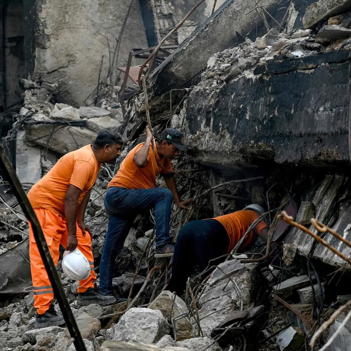 Rescue workers searching for bodies on Jan 21, after a massive fire at Gul Plaza shopping complex in Karachi on Jan 17.