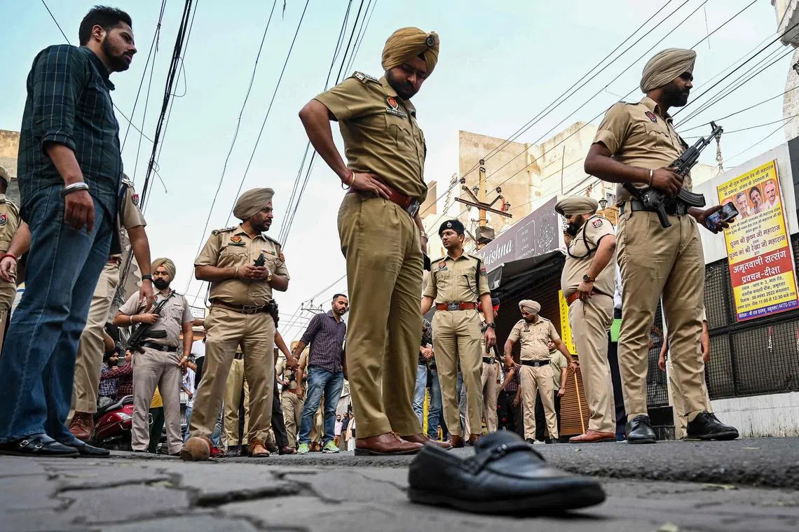 Police officers inspecting the site where Shiv Sena leader Sudhir Suri was shot dead while protesting, in Amritsar, India, on Nov 4, 2022.