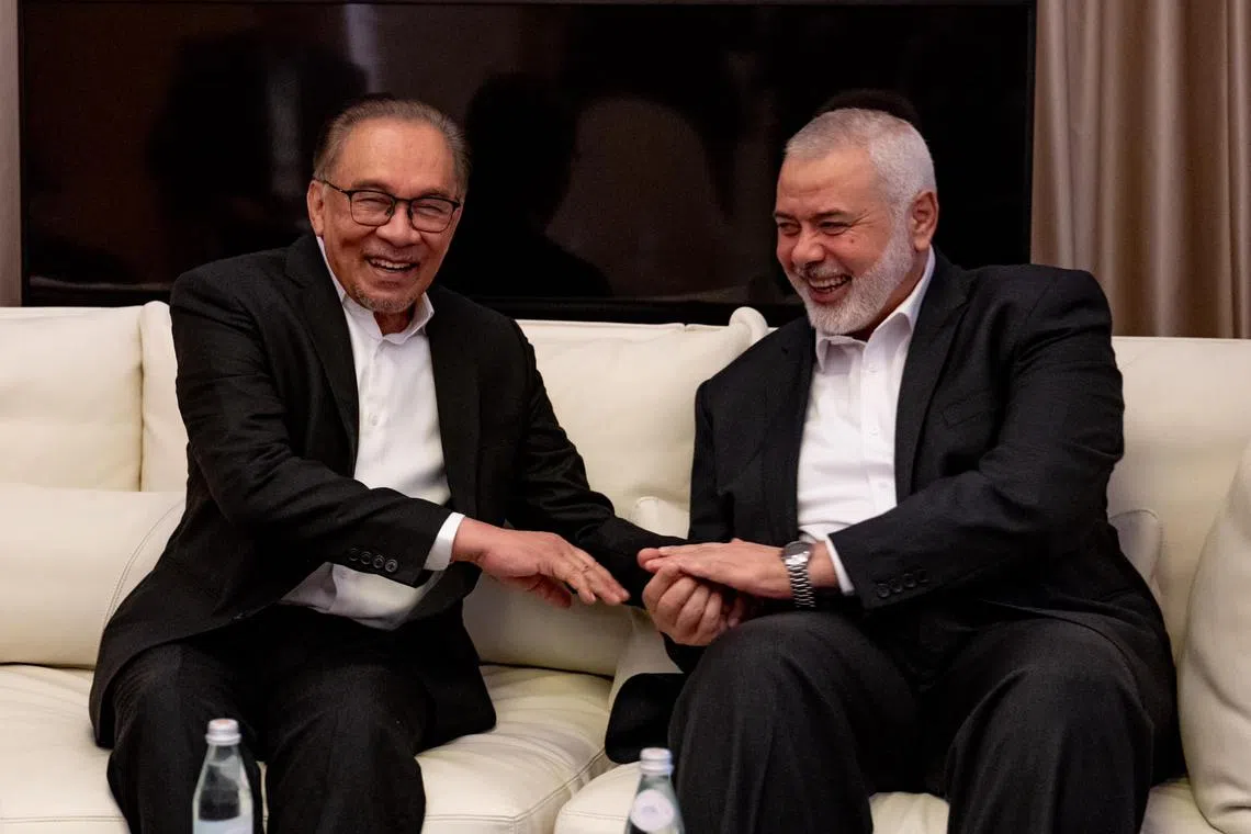 Malaysia’s Prime Minister Anwar Ibrahim (left) met a Hamas delegation led by political leader Ismail Haniyeh in Qatar. 