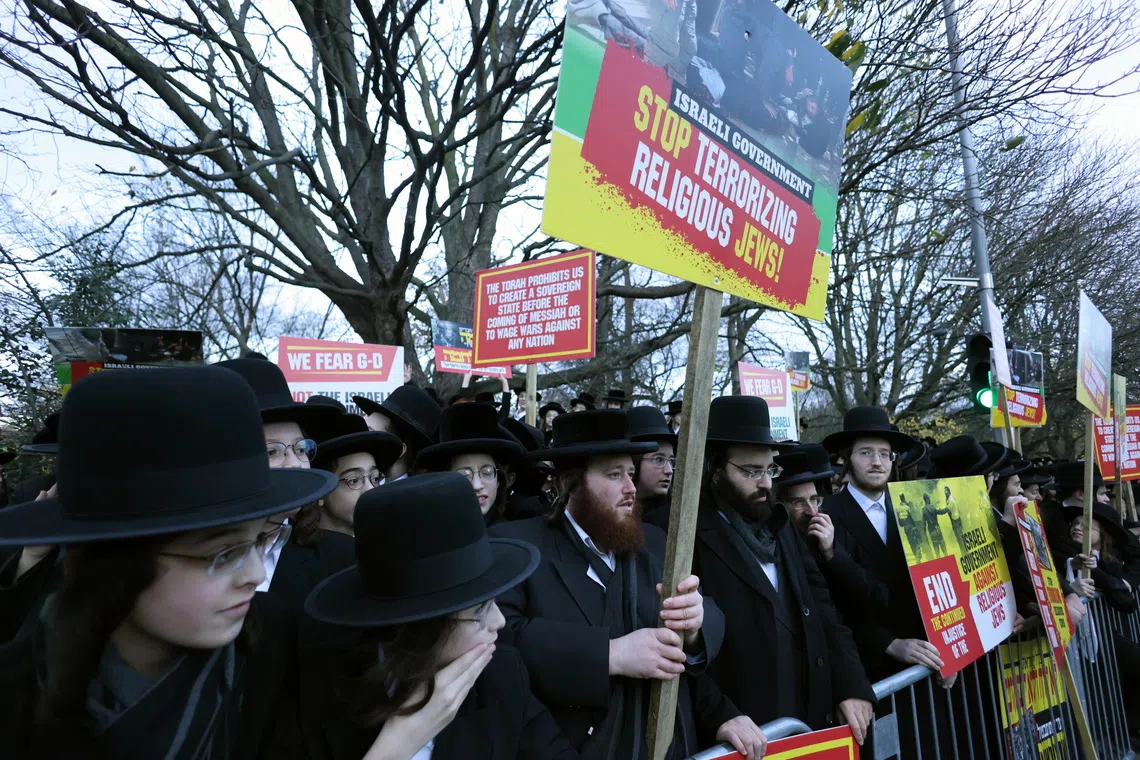 Members of the Orthodox Jewish community demonstrating outside Israel's embassy in London on Dec 11.