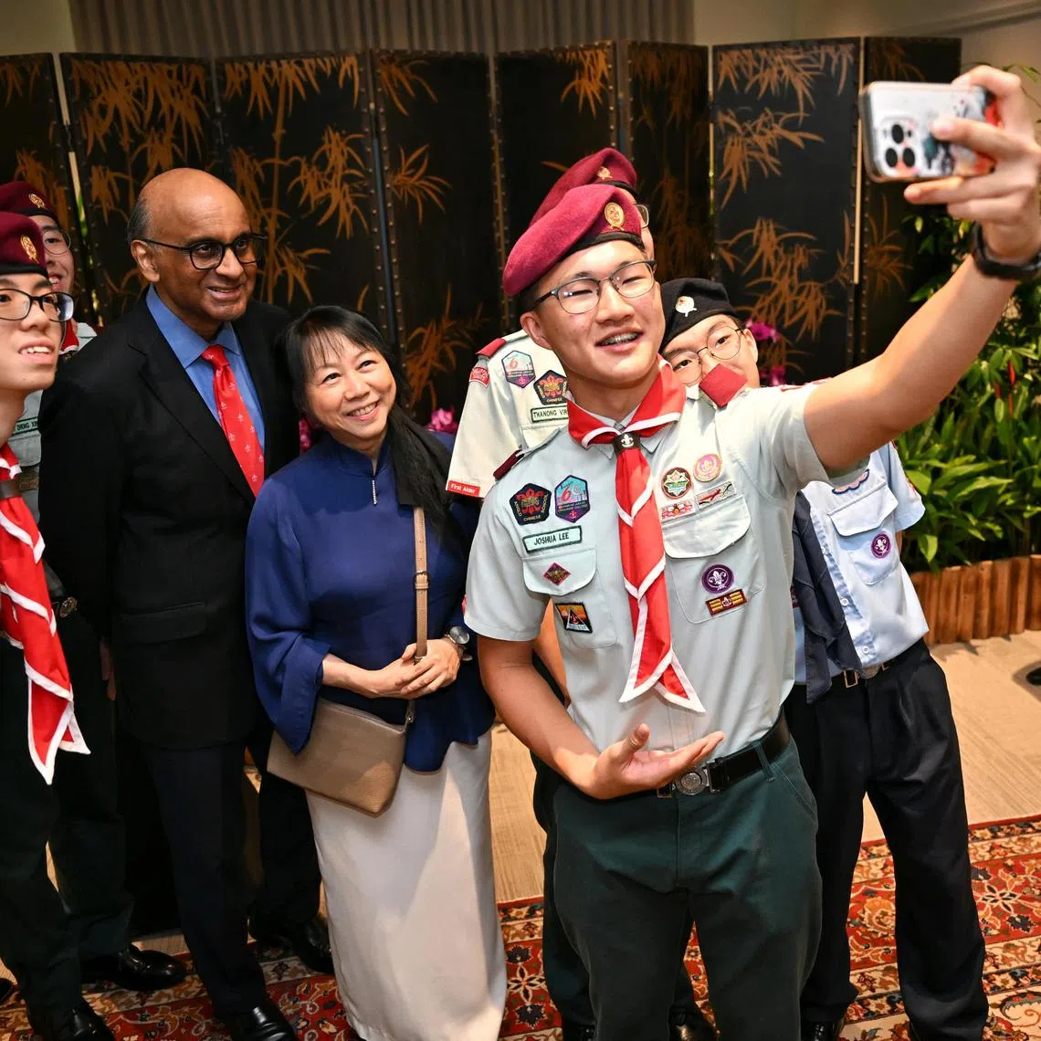 President Tharman Shanmugaratnam and his spouse, Ms Jane Ittogi, taking a wefie with award recipients from the Scouts at the Istana on Dec 2, 2024.