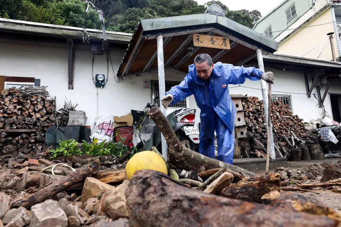 A resident clearing debris in Yilan, Taiwan, on Nov 1 following a landslide caused by Typhoon Kong-rey. Popular tourist destinations such as Japan, Taiwan and Thailand have been hit by deadly natural disasters in 2024.