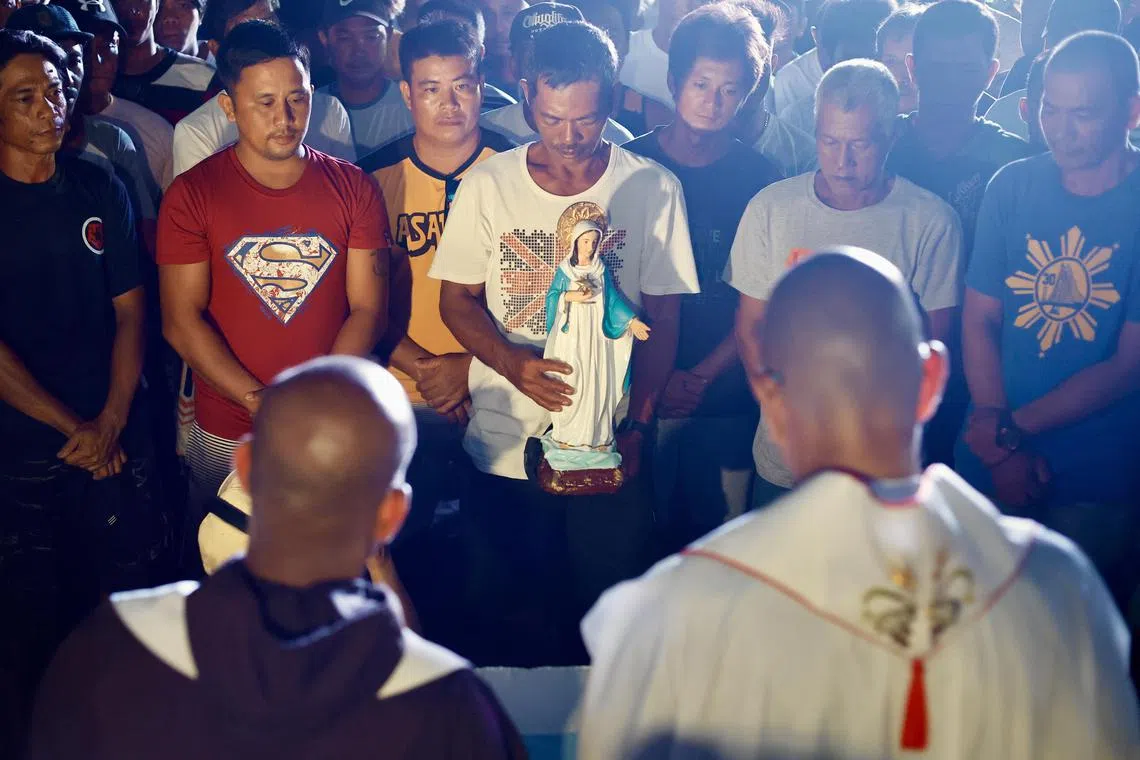 Filipino fishermen are blessed by priests during a mass on the eve of their voyage to Scarborough shoal.