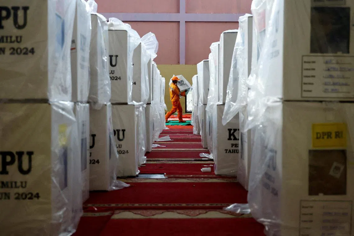 A worker carries a ballot box for distribution to polling stations at a distribution center ahead of the presidential election in Jakarta, Indonesia, February 13, 2024. REUTERS/Kim Kyung-Hoon/File Photo