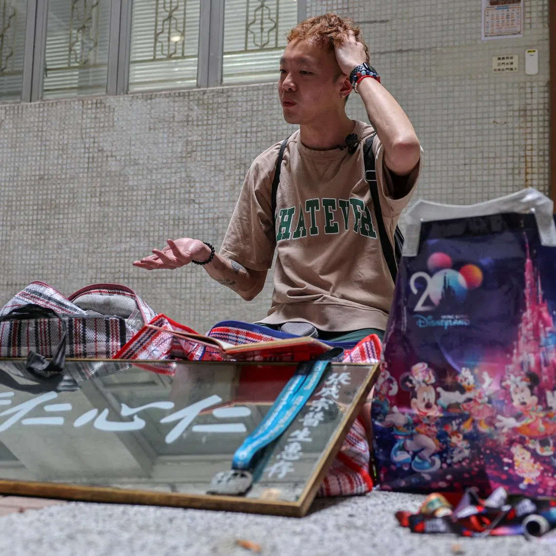 Dorz Cheung, a resident of Wang Fuk Court, shows family belongings, which he retrieved from his flat during his first return visit home since a deadly fire last year, in Hong Kong, China, April 21, 2026. REUTERS/Tyrone Siu