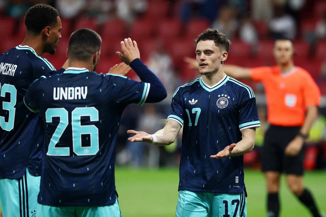 Soccer Football - International Friendly - Germany v Finland - MEWA Arena, Mainz, Germany - May 31, 2026 Germany's Florian Wirtz celebrates scoring their second goal with Felix Nmecha and Deniz Undav REUTERS/Kai Pfaffenbach