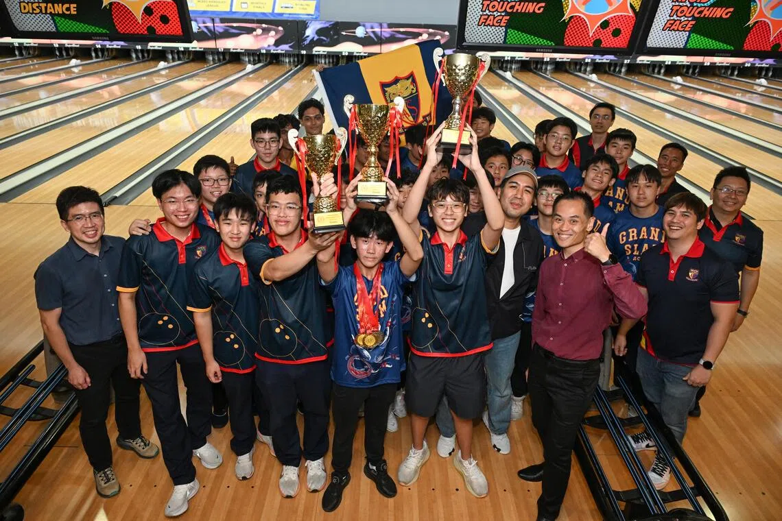 Anglo-Chinese School (Independent)’s A, B and C Division teams posing with their trophies after completing a grand slam of National School Games bowling titles on July 30.  C Division captain Vallen Shin (centre, with three medals) and teacher in-charge Benjamin Wong (with cap) both hailed the team effort.