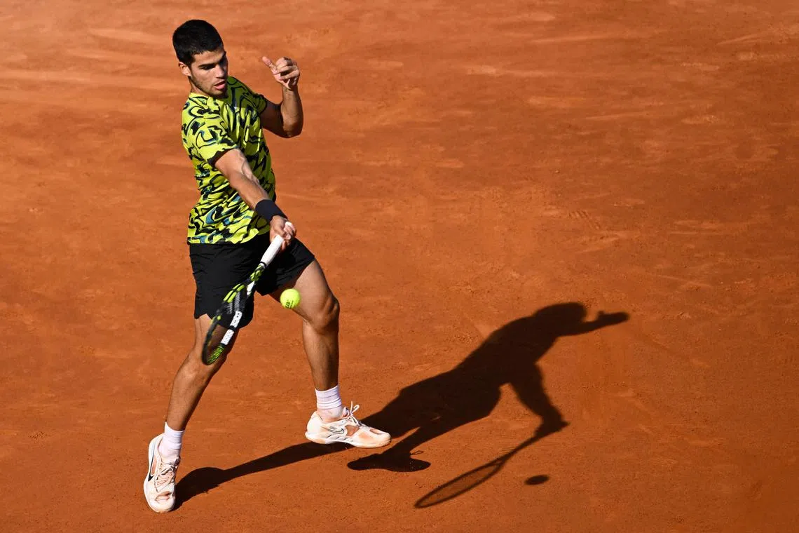Spain's Carlos Alcaraz returns the ball to Spain's Roberto Bautista at the Real Club de Tenis in Barcelona.