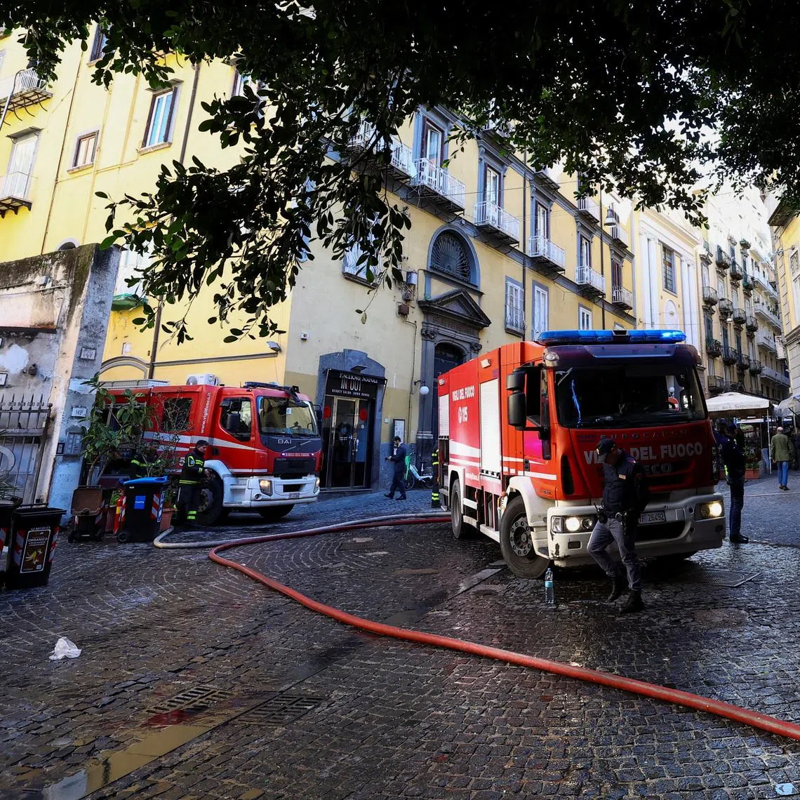 Firetrucks stand next to the historic wood-framed Teatro Sannazaro damaged by fire, in Naples, Italy, February 17, 2026. REUTERS/Ciro De Luca