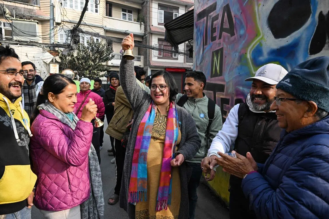 Rastriya Swatantra Party (RSP) election candidate Ranju Darshana (C) meets residents during a door-to-door campaign with her party workers on Feb 13, ahead of Nepal's general election.