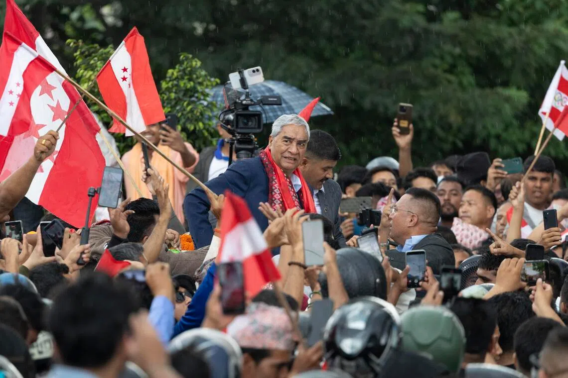 Former Nepal premier Sher Bahadur Deuba returns home, faces graft probe
