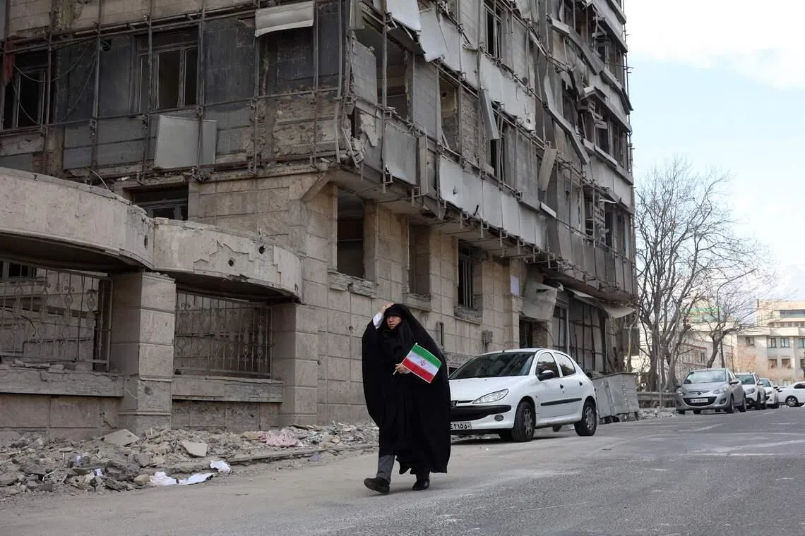 A member of the Iranian medical staff arrive for their protest in front of the destroyed Gandhi Hospital in Tehran on March 7.