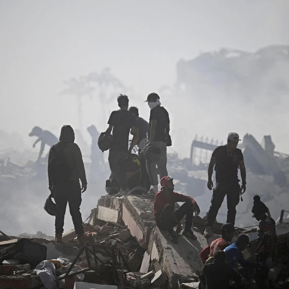 Volunteers comb through the rubble of a collapsed building in La Guaira state, some 40km north-east of Venezuela’s capital Caracas.