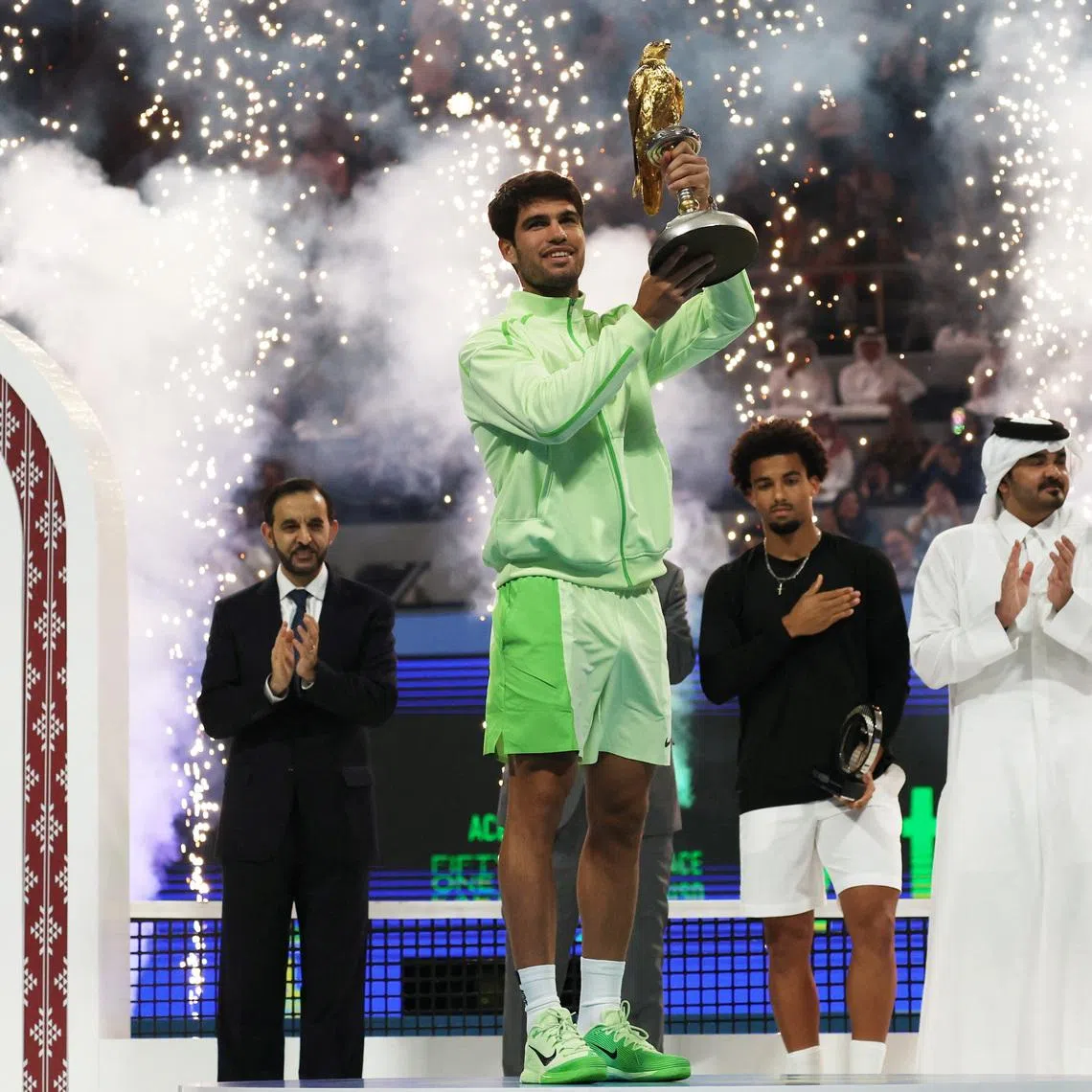 Tennis - Qatar Open - Khalifa International Tennis and Squash complex, Doha, Qatar - February 21, 2026 Spain's Carlos Alcaraz celebrates with the Qatar Open trophy after winning the final match against France's Arthur Fils REUTERS/Mohammed Salem
