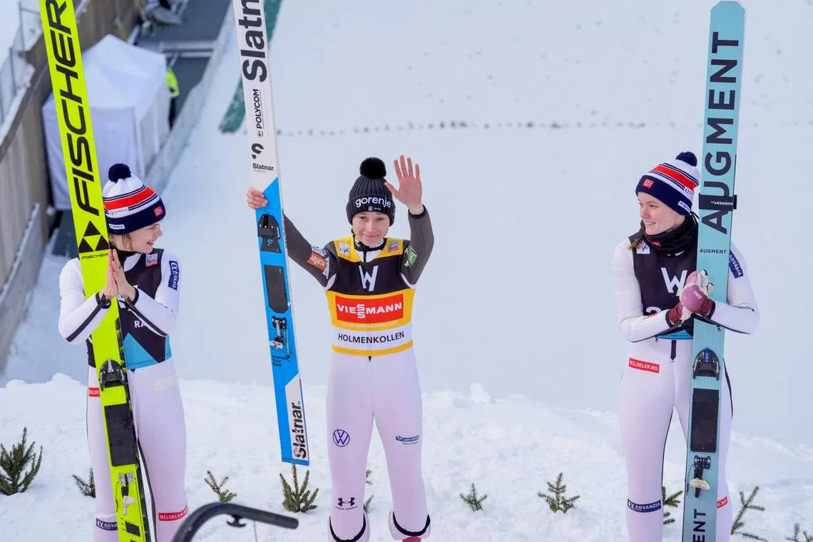 Ski Jumping - FIS Ski Jumping World Cup - Oslo, Norway - March 13, 2025 Slovenia's Nika Prevc celebrates after winning the Women's Large Hill along with second placed Norway's Anna Odine Stroem and third placed Norway's Eirin Maria Kvandal Terje Bendiksby/NTB via REUTERS