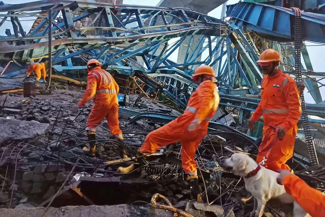 Members of India's National Disaster Response Force inspecting the site on Aug 1, 2023, where a crane collapsed along an under-construction Samruddhi Expressway. At least 17 workers were crushed to death.