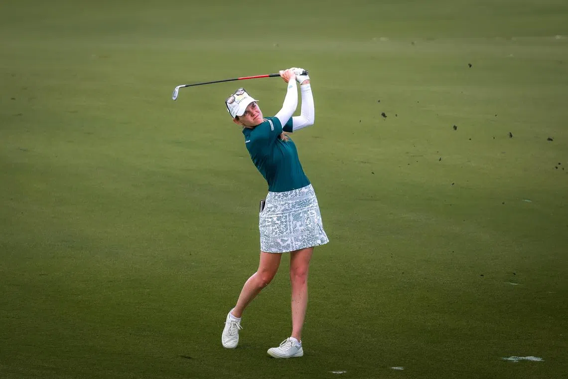 American Sarah Schmelzel (dark green top) fired five birdies in her last nine holes to take the HSBC Women’s World Championship first round lead.