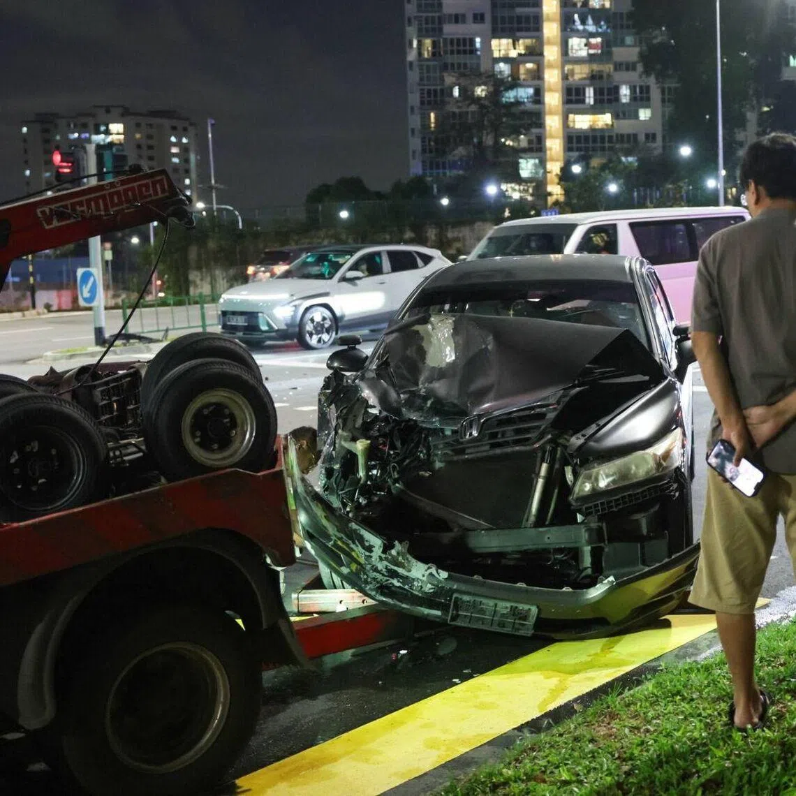 The front bumper of a black car involved in the accident appeared to be badly damaged.