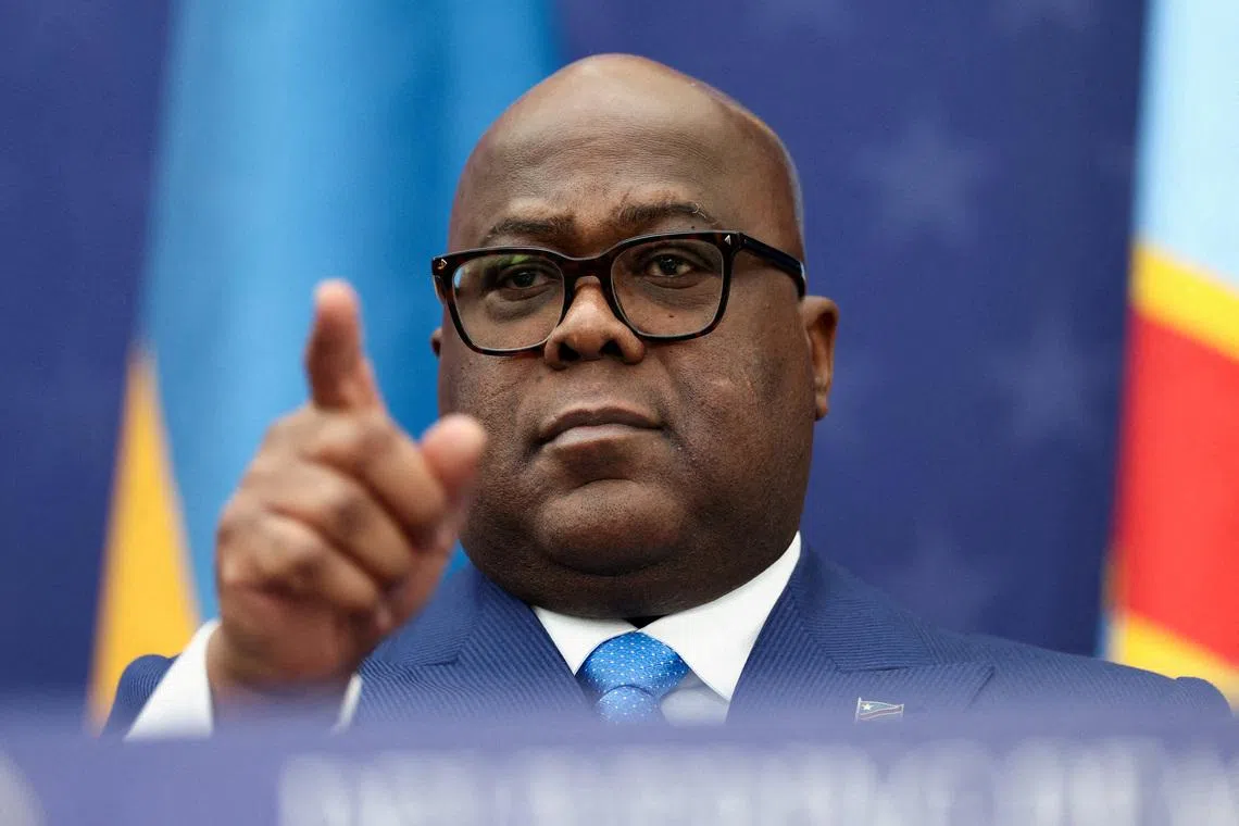 FILE PHOTO: President of the Democratic Republic of the Congo Felix Tshisekedi gestures during a signing ceremony next to U.S. President Donald Trump and President of Rwanda Paul Kagame (not pictured) at the U.S. Institute of Peace in Washington, D.C., U.S., December 4, 2025. REUTERS/Kevin Lamarque/File Photo