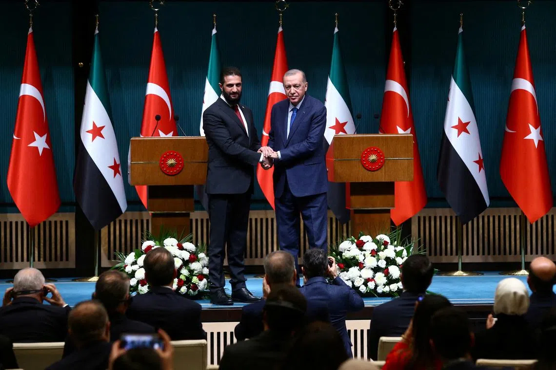 FILE PHOTO: Syria's newly appointed president for a transitional phase Ahmed al-Sharaa and Turkey's President Tayyip Erdogan pose as they shake hands after a joint press conference at the Presidential Palace in Ankara, Turkey, February 4, 2025. REUTERS/Cagla Gurdogan/File Photo