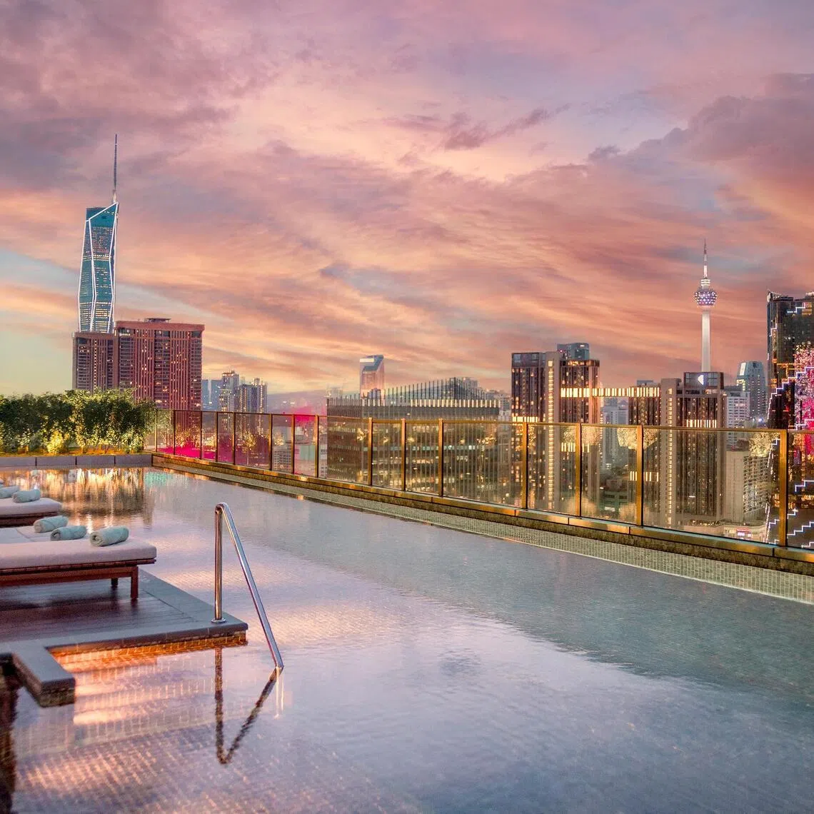 Iconic Malaysian towers Merdeka 118 and KL Tower can be seen from the rooftop pool, 26 storeys up, at Kimpton Naluria Kuala Lumpur.