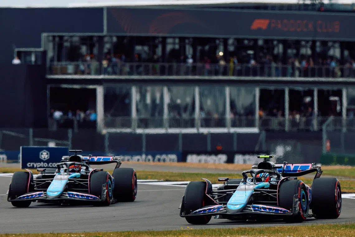 Alpine's French driver Esteban Ocon (left) and Australian reserve driver Jack Doohan at practice on July 5, 2024 ahead of the British Grand Prix at Silverstone.