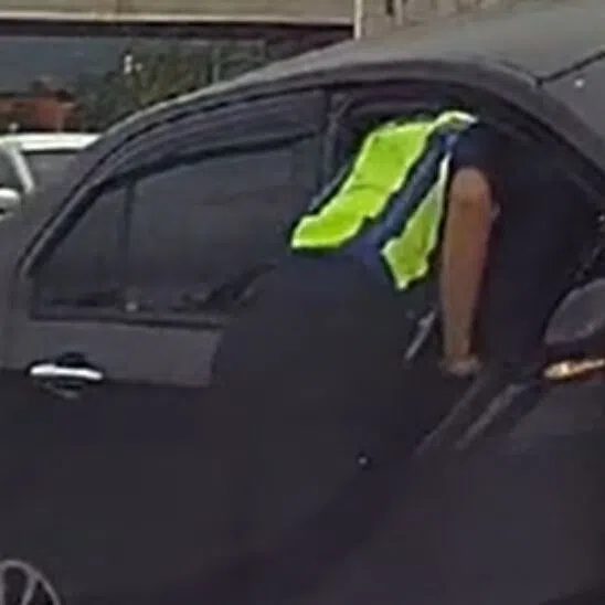 A police officer pulled and bent the door downwards to create a gap.