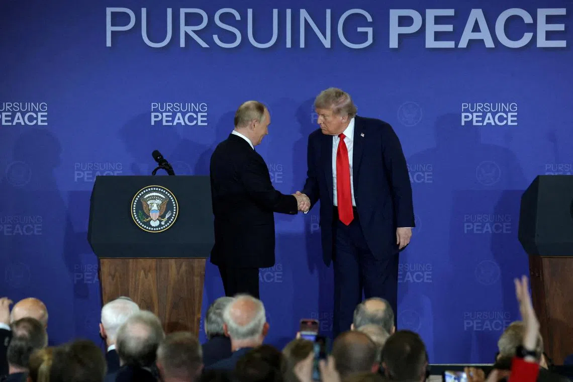 US President Donald Trump and Russian President Vladimir Putin shake hands during a press conference in Anchorage, Alaska, on Aug 15.