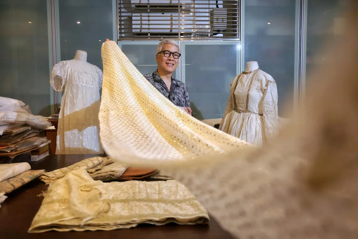 Mr Peter Lee, a textile collector, has many 18th and 19th century muslin fabrics. Here, he holds a modern muslin sari he bought from Bangladesh’s revival project.