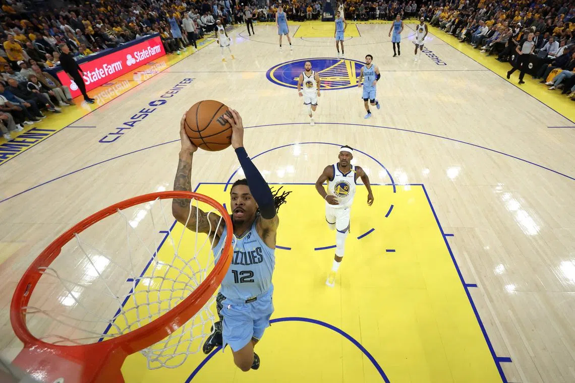 Ja Morant of the Memphis Grizzlies goes up for a dunk on Jimmy Butler of the Golden State Warriors in the first half of the NBA play-in tournament game at Chase Centre.