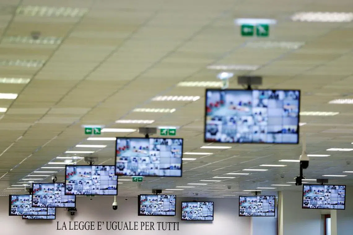 FILE PHOTO: A sign reading \"The law is equal for everyone\" is pictured before a trial against 355 suspected members of the 'Ndrangheta mafia, accused of an array of charges, in a High Security Courthouse in Lamezia Terme, Italy, January 13, 2021. REUTERS/Yara Nardi /File Photo