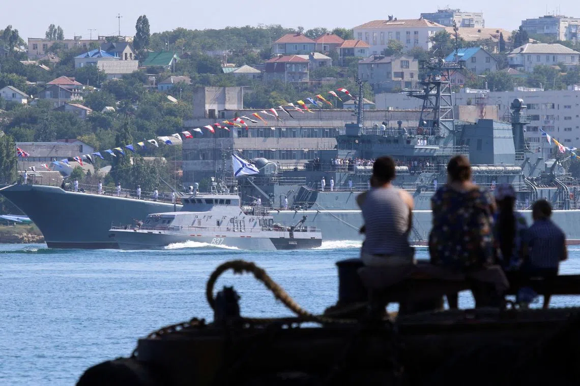 FILE PHOTO: People watch a rehearsal for Russia's Navy Day parade in the Black Sea port of Sevastopol, Crimea July 26, 2019. REUTERS/Alexey Pavlishak/File Photo