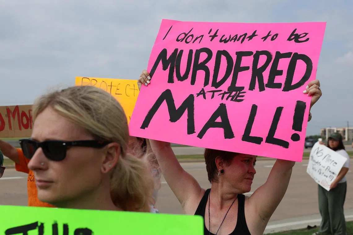People protest against gun violence in Allen, Texas, on Sunday.