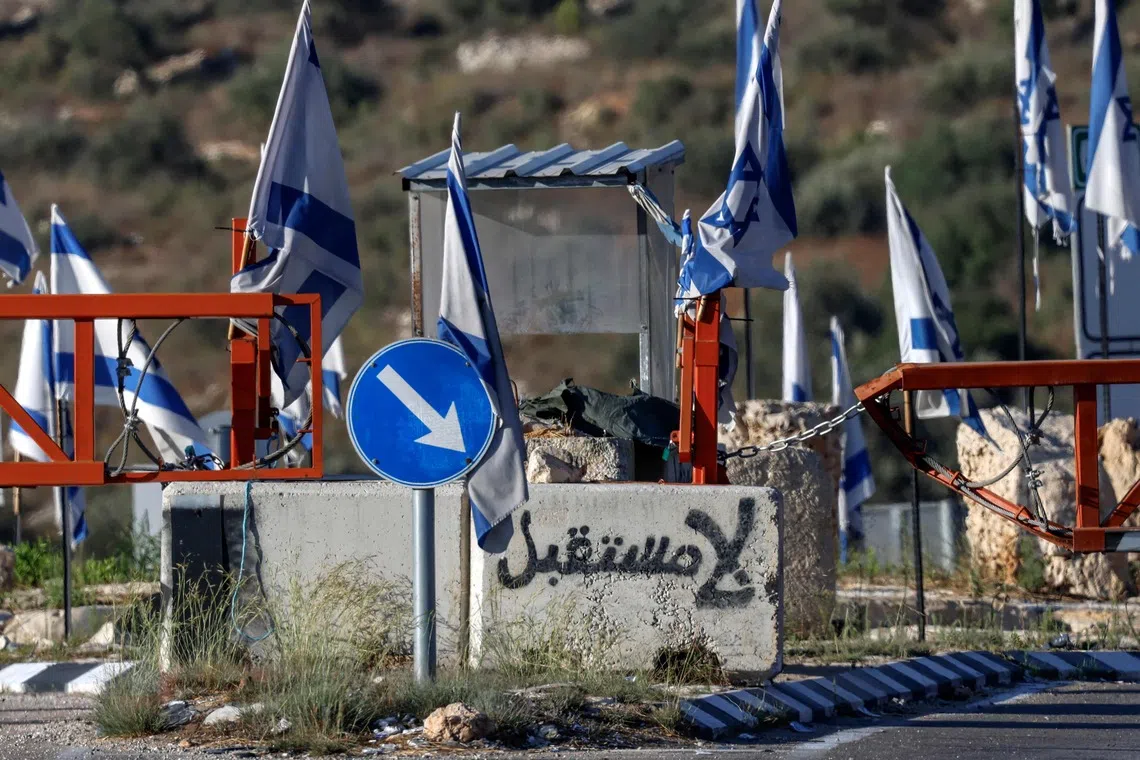 Graffiti reading “no future” in Arabic is depicted on a concrete block at the closed vehicle barrier of a checkpoint at the northern entrance of Ramallah in the Israeli-occupied West Bank.