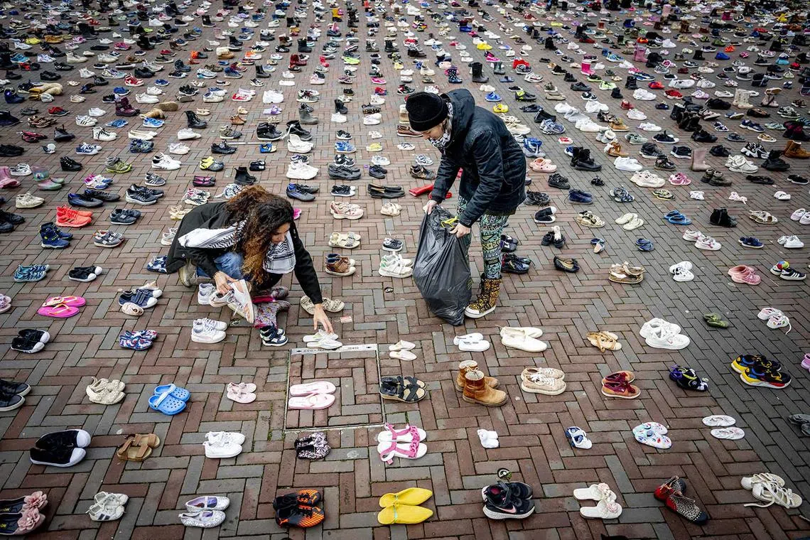 epa11038732 Eight thousand pairs of shoes are displayed on De Binnenrotte in Rotterdam, The Netherlands, 20 December 2023. The shoes symbolize the thousands of Palestinian children who have died in the conflict between Israel and Hamas. Thousands of Israelis and Palestinians have died since the militant group Hamas launched an unprecedented attack on Israel from the Gaza Strip on 07 October, and the Israeli strikes on the Palestinian enclave which followed it. EPA-EFE/ROBIN UTRECHT