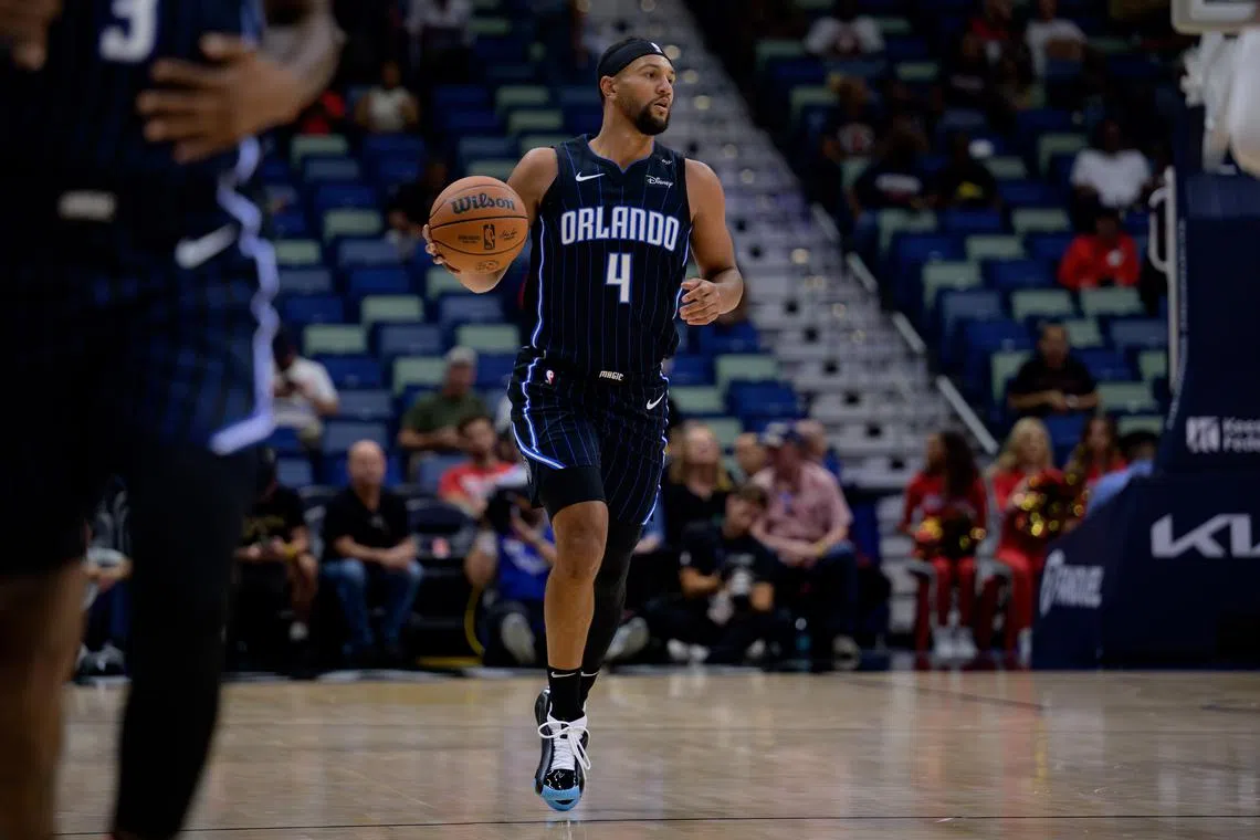 FILE PHOTO: Oct 7, 2024; New Orleans, Louisiana, USA; Orlando Magic guard Jalen Suggs (4) dribbles against the New Orleans Pelicans at Smoothie King Center. Mandatory Credit: Matthew Hinton-Imagn Images/File Photo